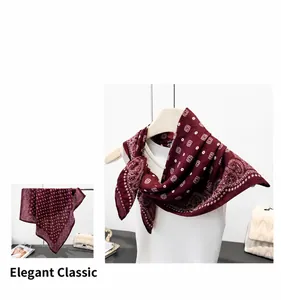 Close-up of burgundy paisley print silk scarf showing elegant pattern and glossy texture