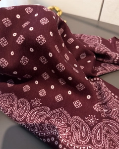 Detailed close-up of wine red paisley scarf showing diagonal twill weave texture