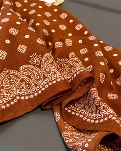 Close-up of herringbone weave and paisley pattern on brown-red cotton-linen scarf
