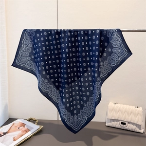 Detail of navy paisley cotton scarf with elegant geometric patterns and wide borders