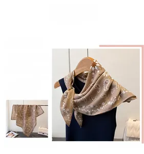 Detail of elegant brown paisley silk scarf showing the sophisticated drape and pattern