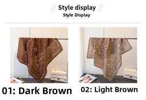 Detail of paisley print silk scarves in dark and light brown with white wavy lace borders
