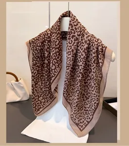 Close-up of leopard print linen-feel square scarf featuring brown and beige animal patterns