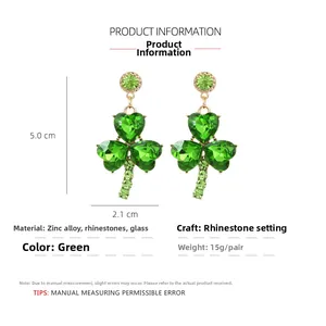 Detail view of 5.0cm green clover earrings with heart-shaped glass and sparkling rhinestones