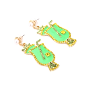 Detail of neon green cocktail cup earrings with sparkling crystals and a pearl stud