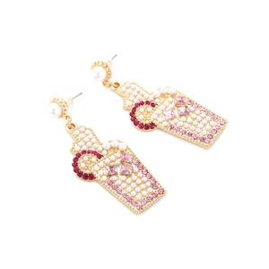 Detail of gold perfume bottle earrings with white pearls and pink rhinestones