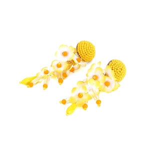 Detailed close-up of handmade yellow beaded flower tassel earrings with fabric petals