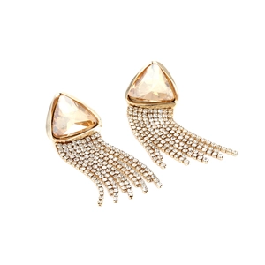 Detailed close-up of golden tassel earrings with champagne crystal and rhinestone chains