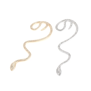 Dettaglio di orecchini a serpente con strass in finiture color oro e argento lucido