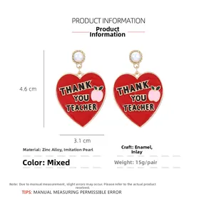 Detail of Teacher Day heart earrings with Thank You Teacher text and white pearl stud