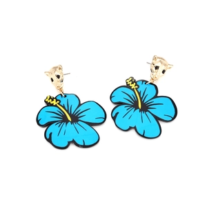 Detailed view of tropical blue floral earrings with golden leopard head studs