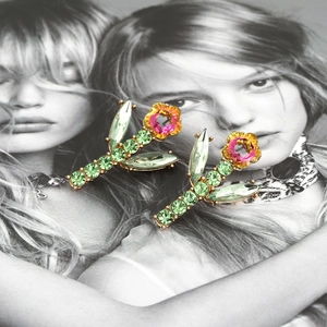 Elegant floral stud earrings with green leaf crystals and gradient pink yellow flower