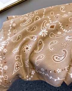 Detail of camel paisley patterned cotton scarf showing premium twill weaving texture