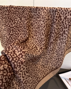 Close-up of leopard print shawl with sheer texture and premium hemmed edges