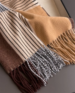 Detailed macro shot of multi-color striped tassel scarf with soft cashmere-like texture