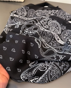 Close-up of black and white paisley bandana showing detailed twill fabric texture