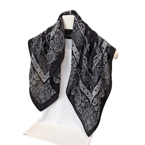 Classic black and white paisley cotton scarf draped elegantly on a mannequin for women