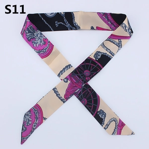 Macro detail of silk scarf with vintage carriage wheel patterns and diagonal cut ends