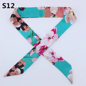 Close-up of floral twilly silk scarf in lake green with diagonal ends for bag handle