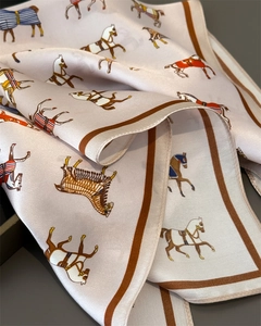 Detail eines Seidenschals mit Reitsport-Pferdeprint und handrollierten braunen Kanten