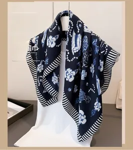 Detail of dark blue scarf with white polka dots and chic abstract floral patterns