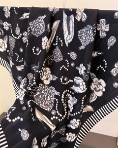 Detail of silk scarf showing white camellia, pearl chain patterns and striped edges