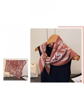 Detail eines braunen Halstuchs mit Paisleymuster über einem schwarzen Ripptop