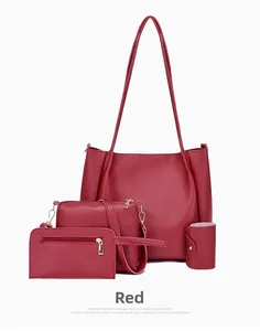 Detail of burgundy four-piece bag set with tote bag, crossbody, wallet and gold hardware