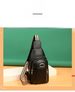 Detail of black pebbled leather chest bag with quilted diamond pattern and striped strap