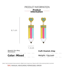 Detailed view of pink and blue enamel pencil earrings with heart rhinestone studs