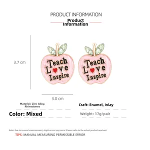 Detail view of apple earrings with Teach Love Inspire text and size measurements