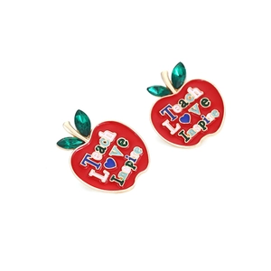 Detail of red apple earrings featuring Teach Love Inspire text and faux gems
