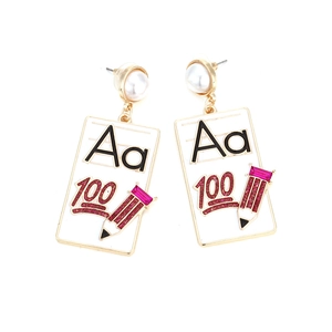Détail de boucles d'oreilles émaillées avec lettres, chiffre 100 et breloque crayon rose