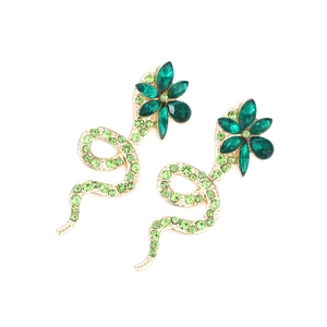 Close-up of snake earrings with floral heads and green rhinestones in gold alloy