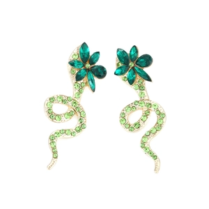 Golden snake earrings with green crystals and floral design in a centered frontal view
