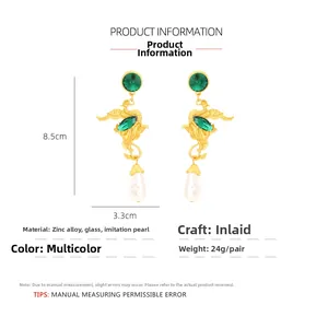 Detail of vintage phoenix earrings with green crystal and teardrop pearl drops