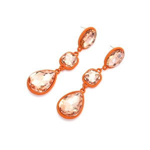 Macro detail of champagne crystal teardrop earrings with orange lacquer metal base