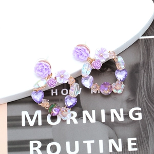 Elegant purple crystal heart and floral earrings set with a golden metal finish