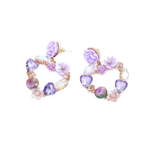 Handmade purple floral heart stud earrings with crystals and resin flowers on white background