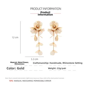 Detailed view of long gold flower tassel earrings showing 12cm by 5.3cm size dimensions