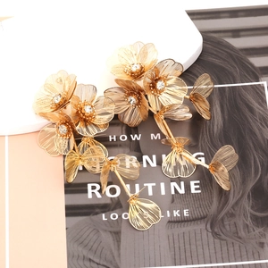 Exaggerated golden floral tassel earrings with sparkling rhinestones and hollow leaves