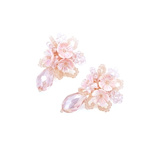 Detail of handmade pink beaded flower earrings with multi-layered petals and crystal drops