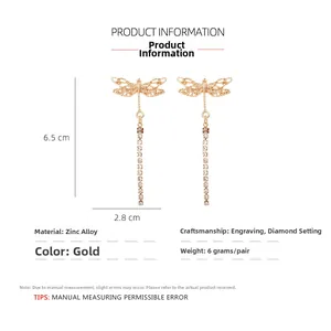 Detail showing golden dragonfly earring size 6.5cm by 2.8cm with rhinestone tassels