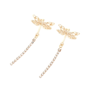 Detailed close-up of golden dragonfly earrings with delicate hollow wings and crystal tassels