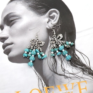 Boucles d'oreilles bohèmes vintage avec nœud, perles turquoise et pompons
