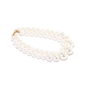 Detail of double-layer baroque pearl necklace with golden lobster clasp on white background
