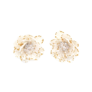 Detail of white flower stud earrings with gold edges and crystal center petals