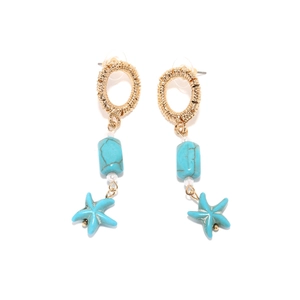 Bohemian gold starfish drop earrings with turquoise stones and white beads on white backdrop