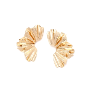 Macro view of golden layered ginkgo leaf earrings with detailed pleated metal texture