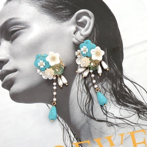 Bohemian floral tassel earrings with turquoise and pearls on fashion magazine background